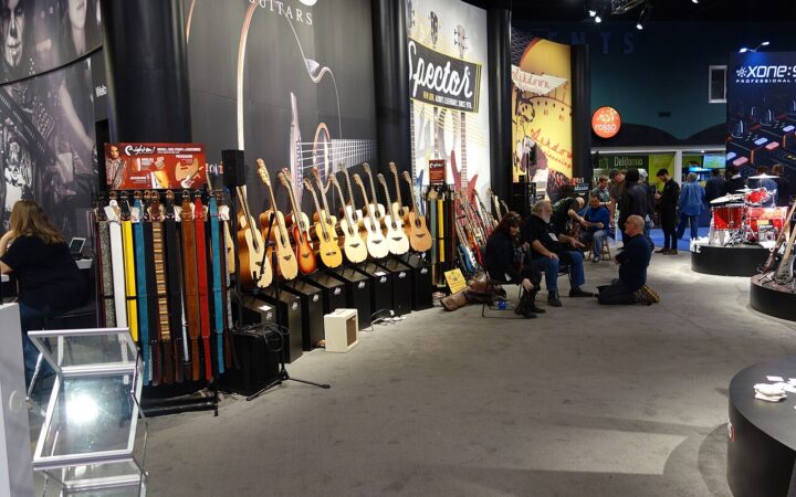 A row of acoustic guitars displayed at the 2016 NAMM Show.