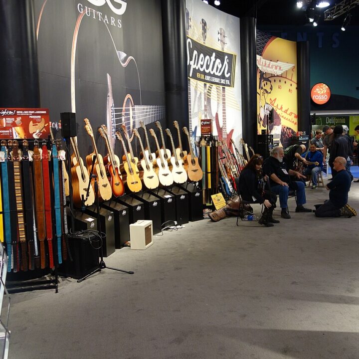 A row of acoustic guitars displayed at the 2016 NAMM Show.