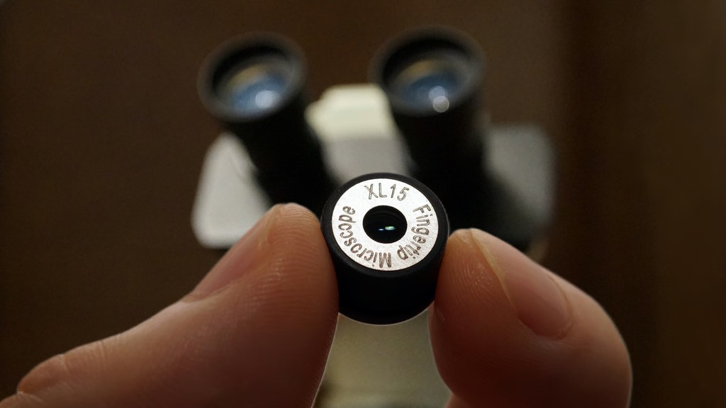 iMicro XL15 fingertip microscope lens held between two fingers