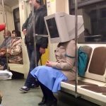 computer monitor taking the ride in a subway