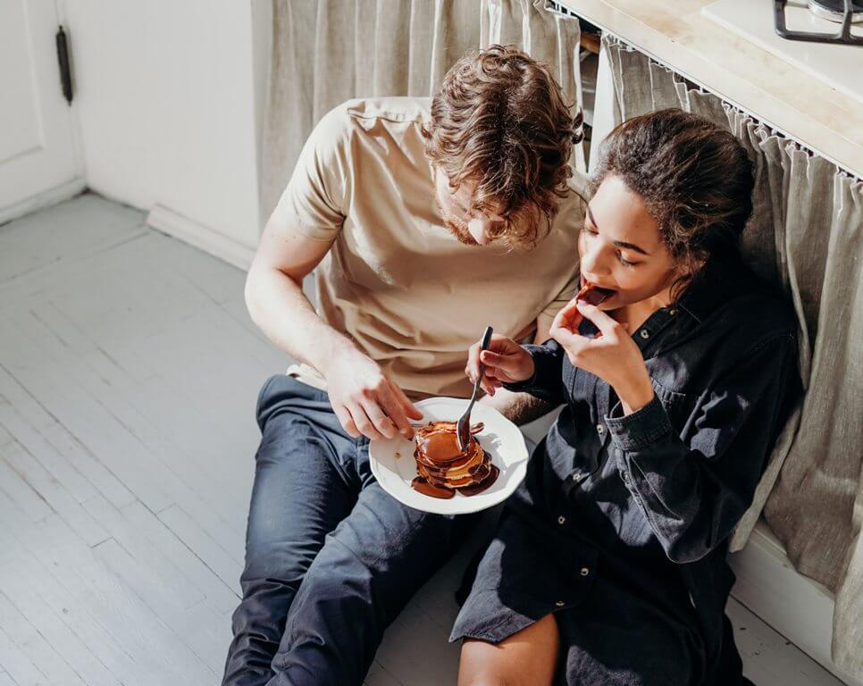 couple enjoying food at home