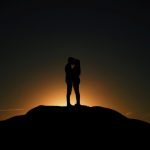 couple kissing sunset