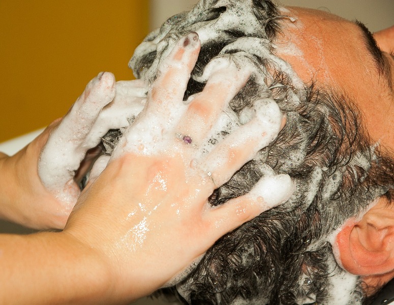 hairdresser putting shampoo